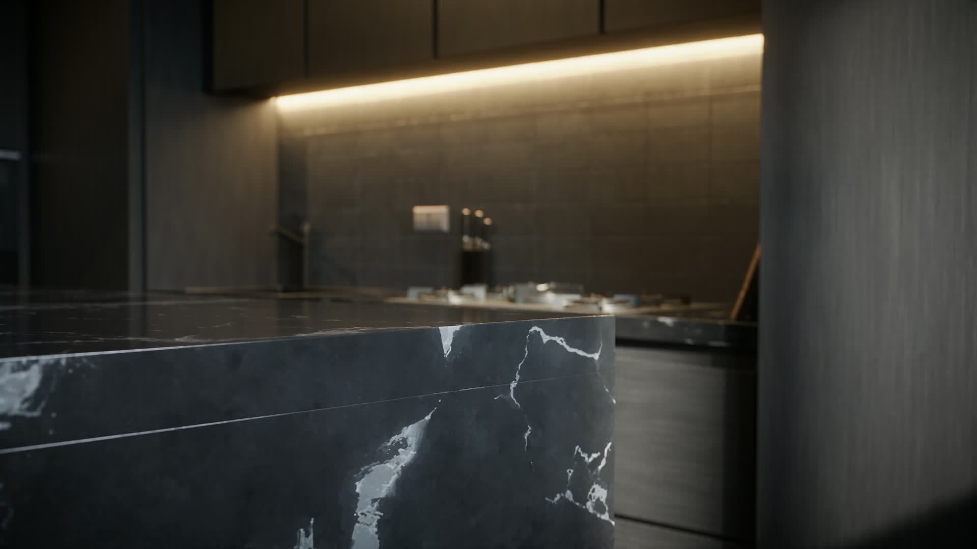 A dark modern kitchen with a black marble island and warm light lines